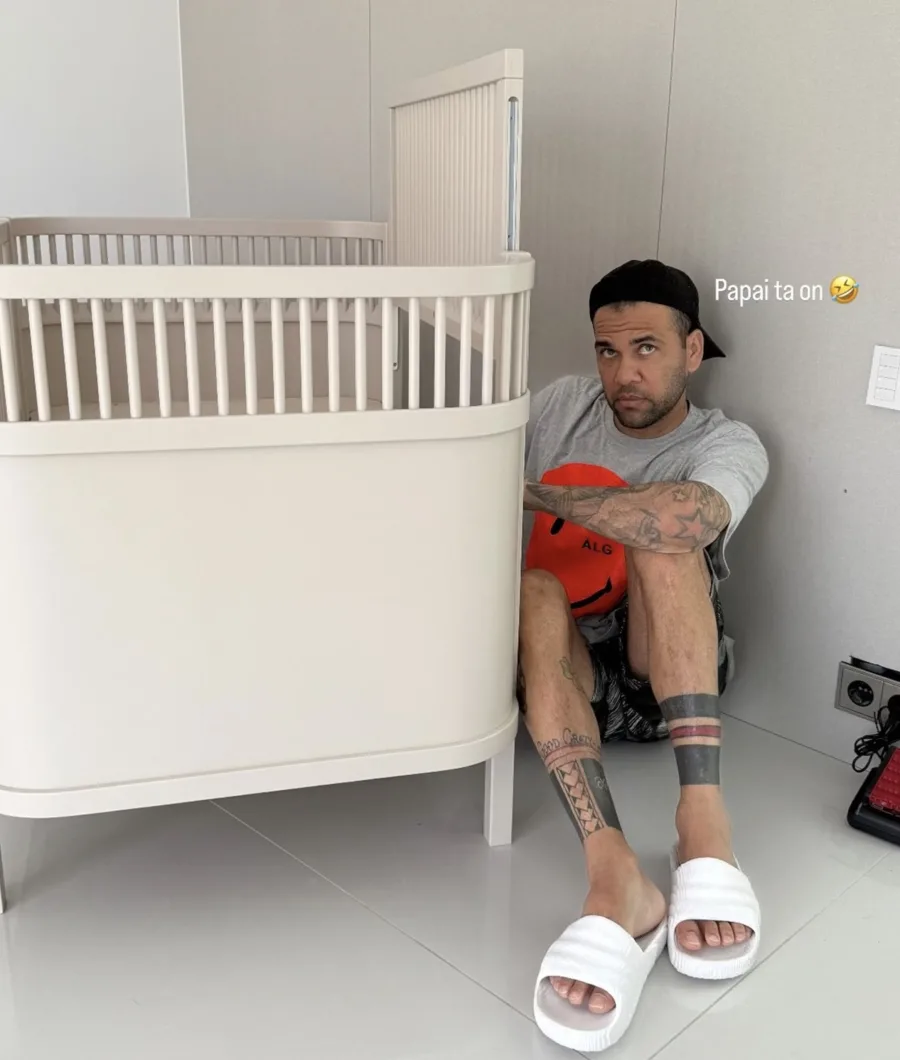 No Instagram, Joana Sanz mostrou Daniel Alves montando o berço do primeiro filho do casal, usando chinelo branco e boné preto, em um momento íntimo e especial.