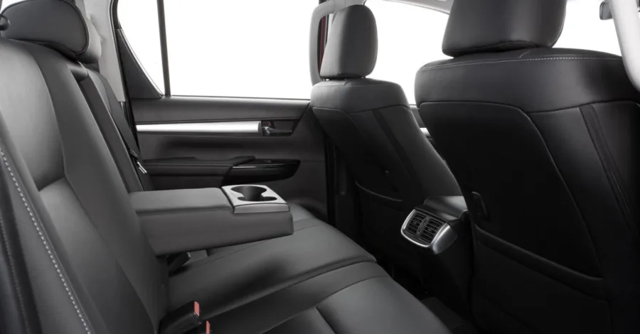 O interior tem espaço para 5 pessoas, bancos de couro com ventilação, som JBL e ar-condicionado digital de duas zonas, além de caçamba de 1000 litros e carga útil de 1000 kg.