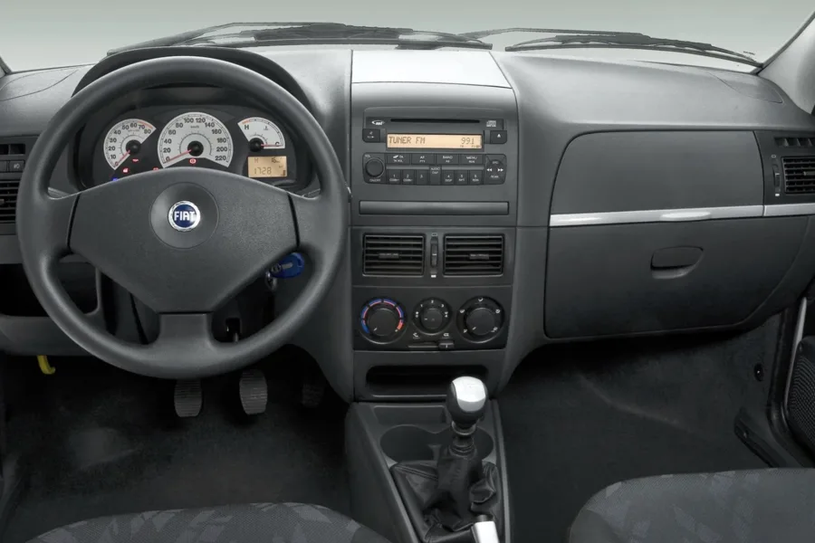 O interior é simples, com dois lugares e foco em durabilidade. O conforto é básico e a proposta prioriza trabalho, não refinamento ou silêncio a bordo.